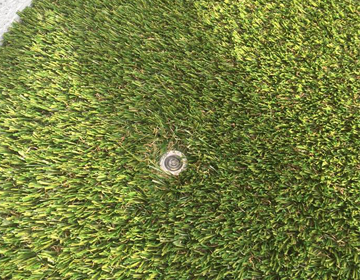 Spotlight integrated into artificial grass close up
