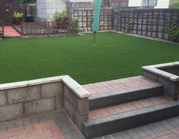 Raised area with sleepers and artificial grass