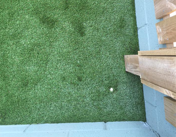 Spotlight integrated into artificial grass from above